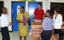 Eighth-grader Esaias Charles leads the Middle States inspection team on a tour of John H. Woodson Jr. High School on Wednesday. 